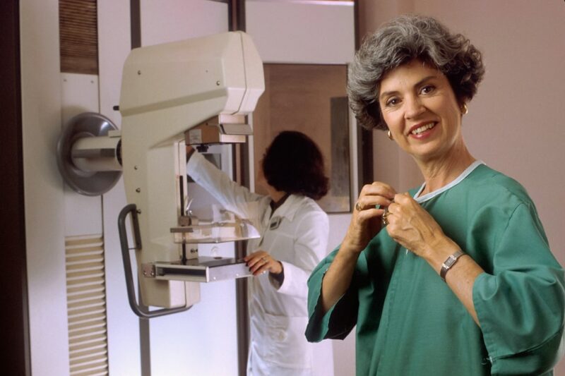 Patient undergoing mammography with a healthcare professional, illustrative image